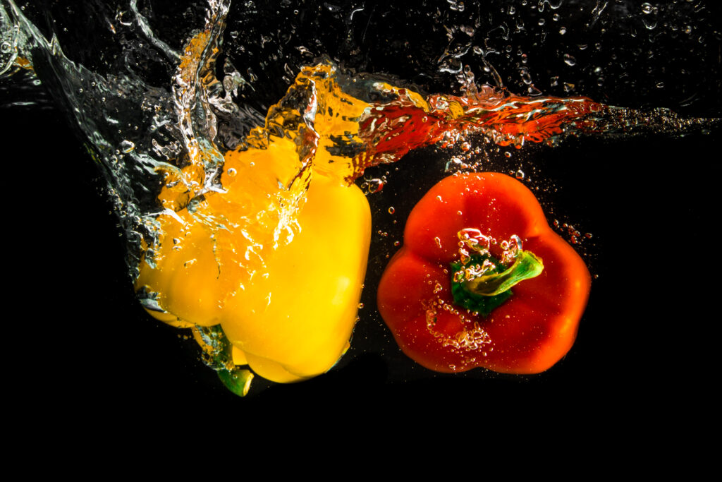 Vibrant Yellow & Red Pepper Splash Wallpaper with Dynamic Water Bursts