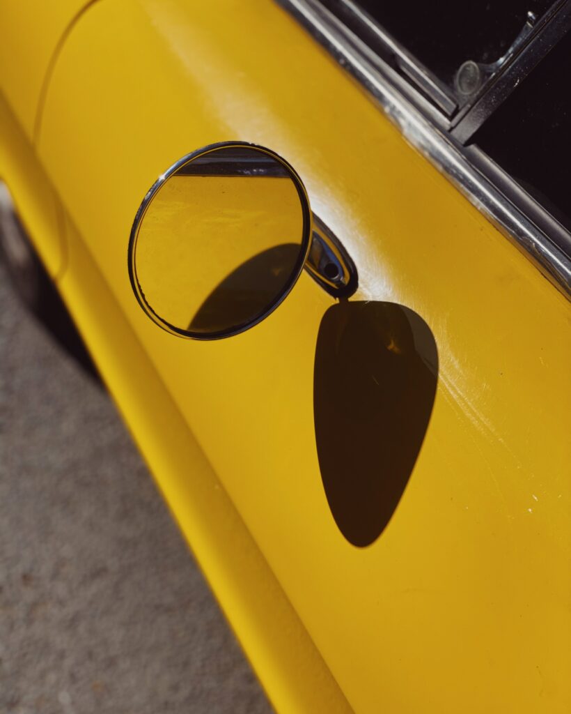 Close-Up Retro Car Wallpaper: Vibrant Yellow & Classic Design