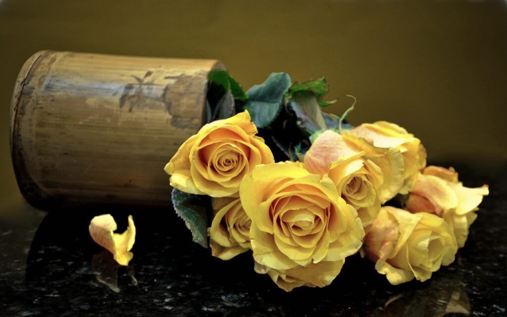 Vibrant Yellow Roses in Rustic Vase - Elegant Floral Background Wallpaper