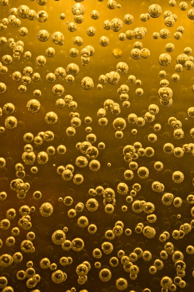 Vibrant Yellow Bubble Wallpaper: Dynamic Liquid Textured Background