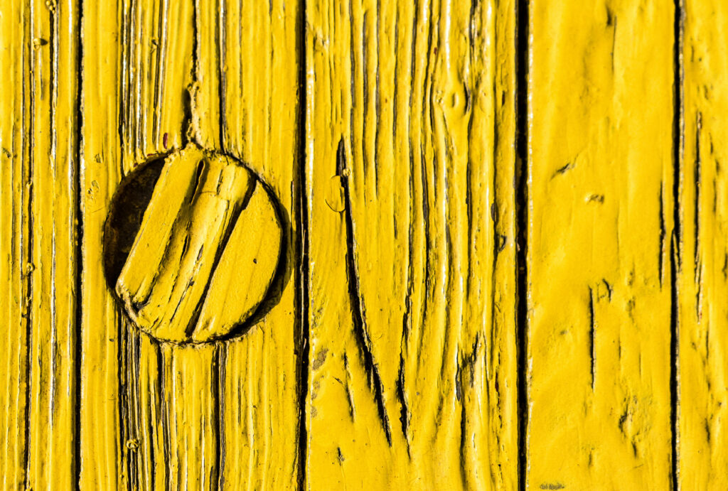 Rustic Yellow Wallpaper with Textured Planks and Circular Detail