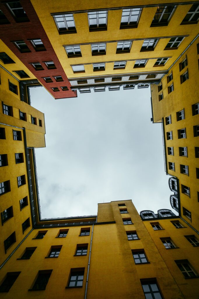 Vibrant Yellow-Red Building Wallpaper: Captivating Sky Perspective