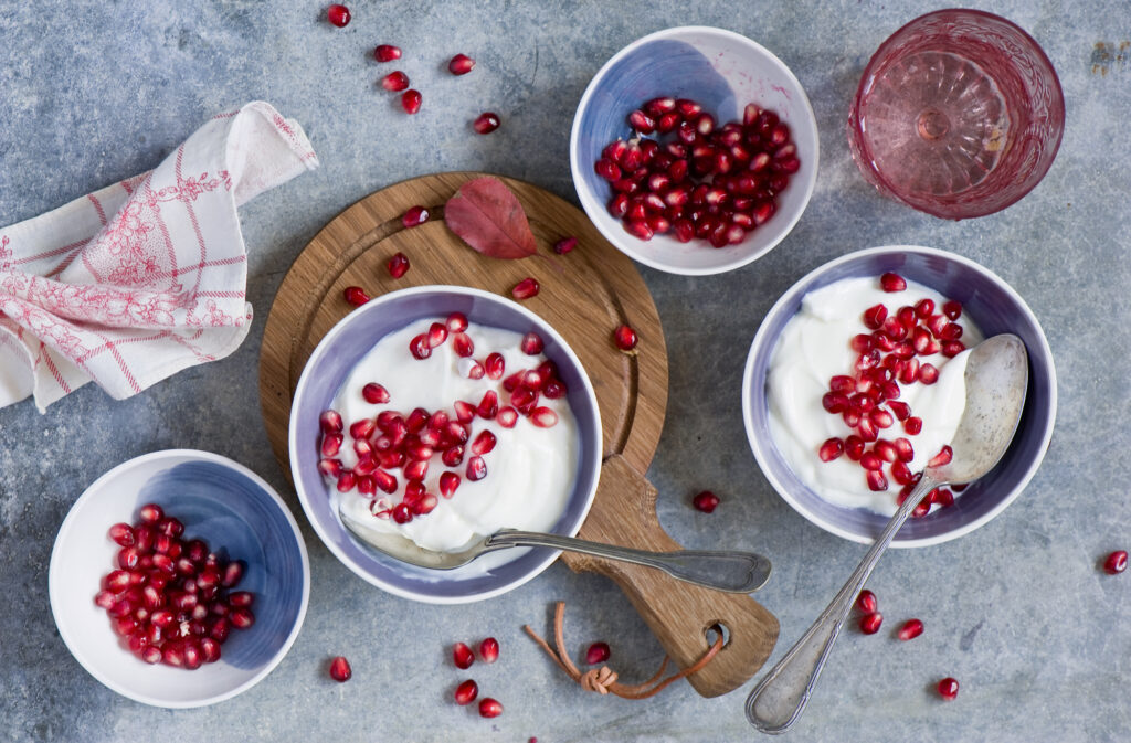 Vibrant Yogurt & Pomegranate Wallpaper: Rustic Food Scene