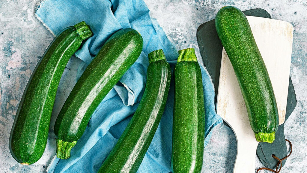 Vibrant Zucchini Wallpaper: Fresh Green Veggies on Textured Surface