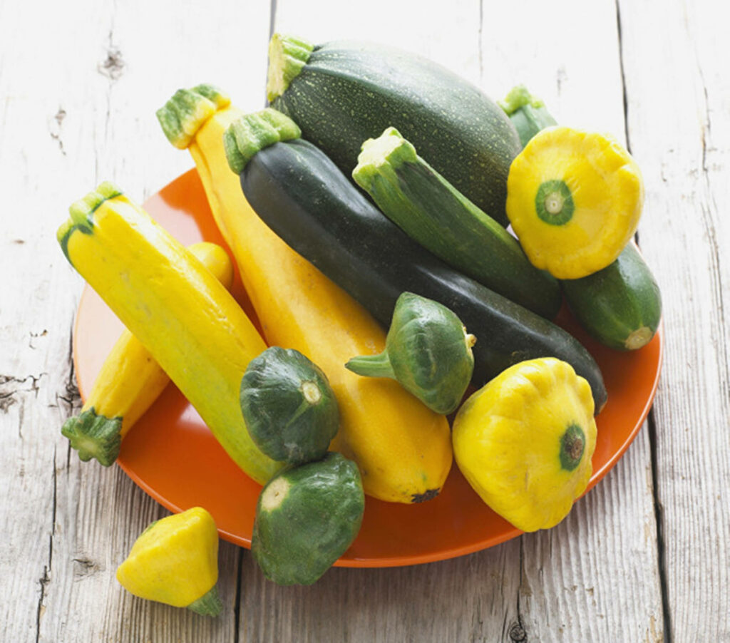 Colorful Zucchini & Yellow Squash Wallpaper on Rustic Wood Background