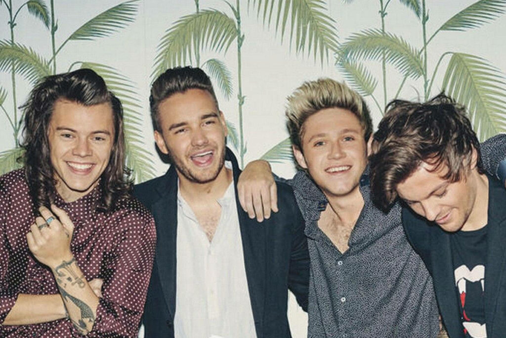 The Colorful Brotherhood: One Direction, Spreading Happiness in Vibrant Attire Wallpaper