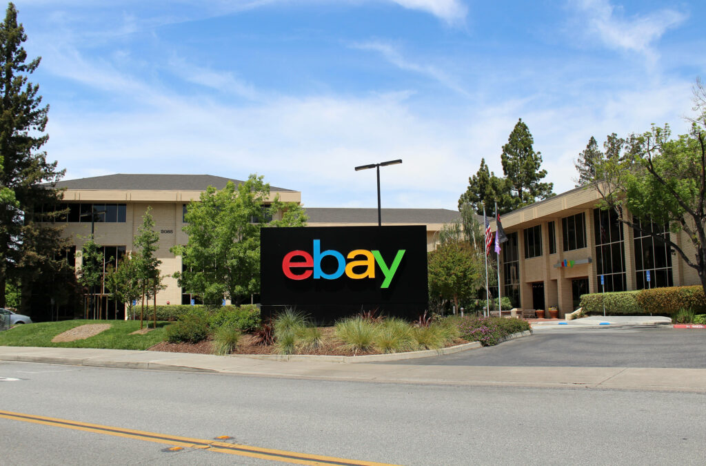 eBay logo colorful sign outside modern eBay office campus with green trees and clear sky wallpaper