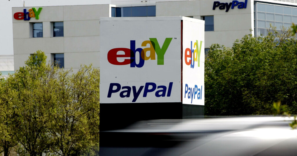 Vibrant eBay and PayPal logos on modern building with green trees and blurred passing vehicle Wallpaper