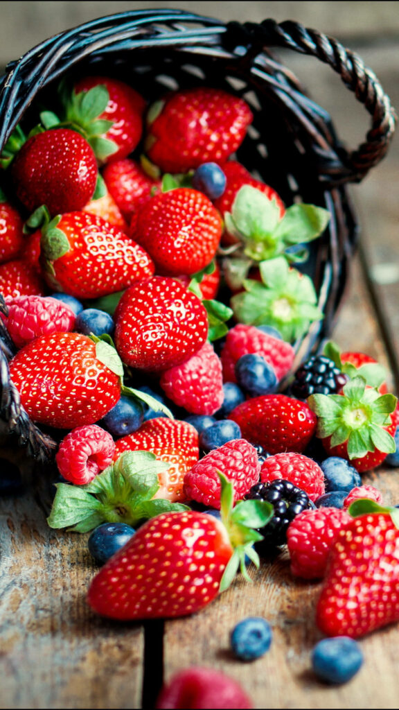 Vibrant Berry iPhone Wallpaper: Rustic Basket on Wooden Background