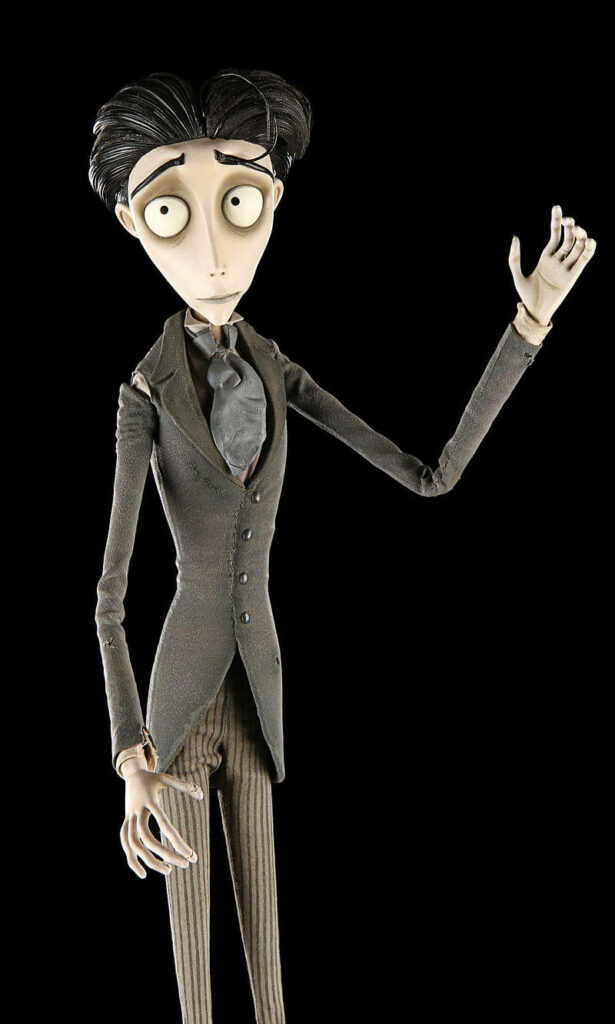 Victor Van Dort from Corpse Bride in Victorian attire with raised arm on black background wallpaper