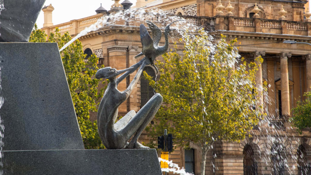 Victoria Square Fountain bronze sculpture with birds cascading water historic Adelaide trees Wallpaper
