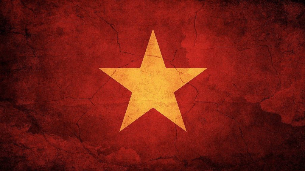 Vietnam National Flag wallpaper with yellow star on red grunge textured background vibrant design