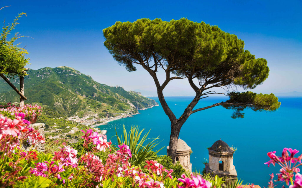 Breathtaking Villa Rufolo Garden view with colorful flowers pine tree turquoise sea Amalfi Coast Wallpaper