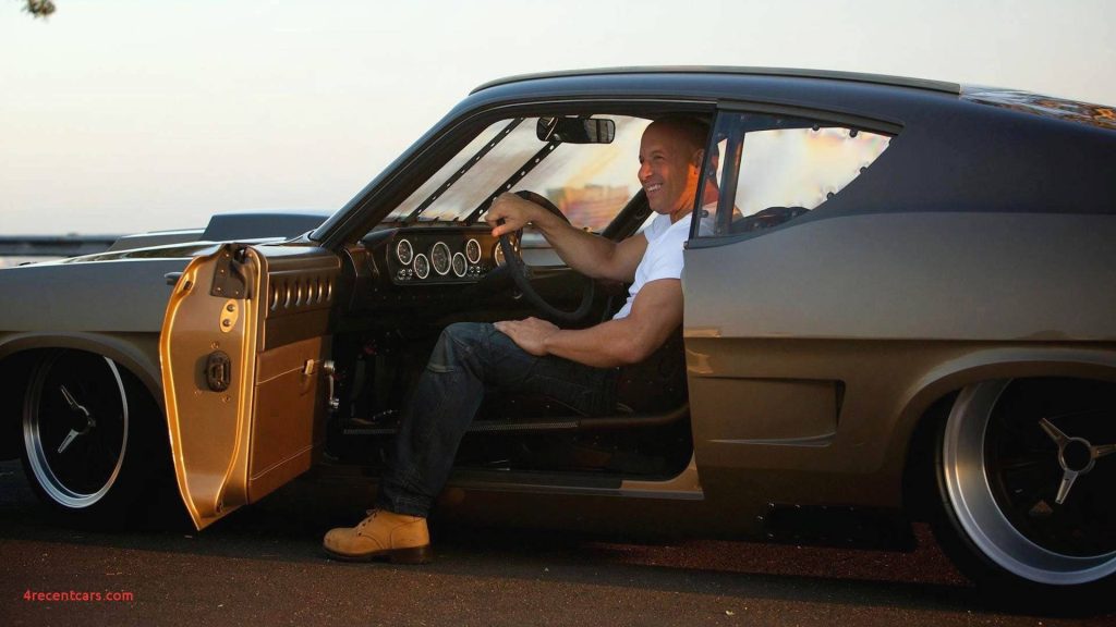 Vin Diesel seated in custom muscle car golden hour cinematic wallpaper for car enthusiasts