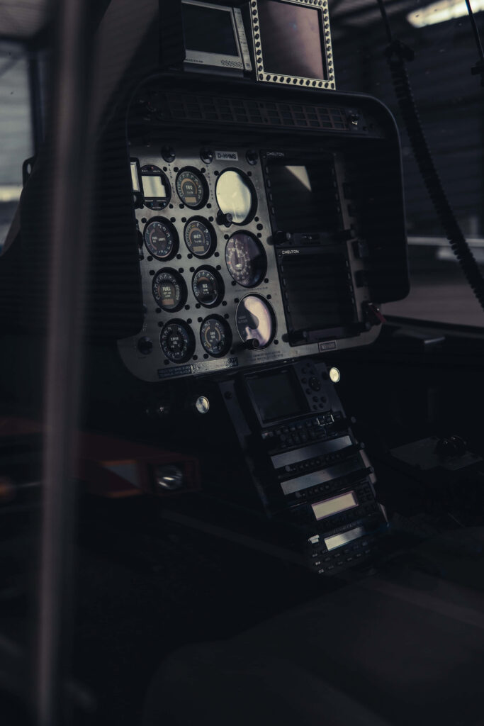 Vintage aircraft cockpit panel with analog dials gauges and switches in muted metallic tones Wallpaper