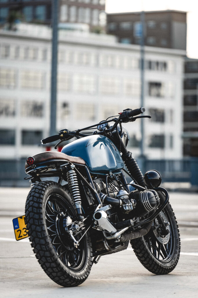 Vintage Sleek Black Motorcycle with Urban Charm - Wallpaper Background