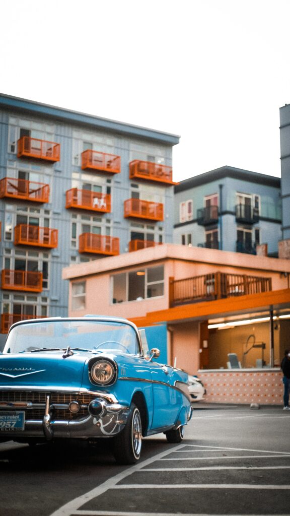 Retro Blue Car Wallpaper: Vintage Style in Urban Colorful Scene