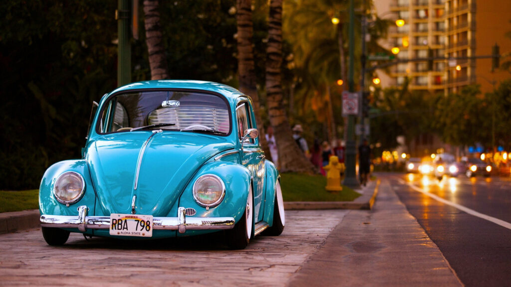 Classic Charm: Capturing a Vintage Blue Volkswagen Car Parked on a Scenic Road Wallpaper