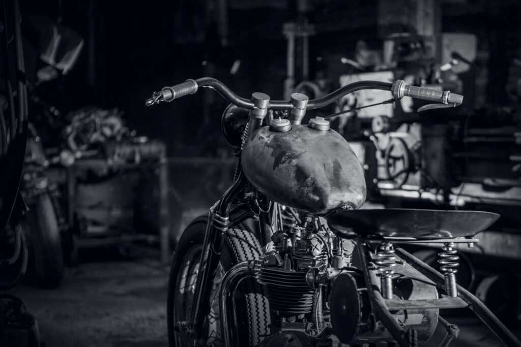 Vintage Bobber Motorcycle Wallpaper in Rustic Garage - Retro Aesthetic