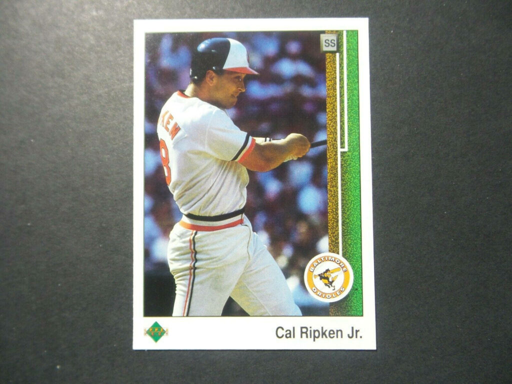 Vintage Cal Ripken Jr Orioles baseball card mid-swing retro colors white border wallpaper background