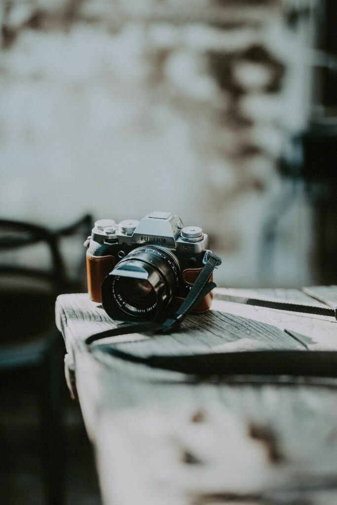Vintage Camera Wallpaper: Intricate Design on Wooden Table