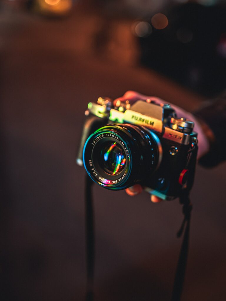 Vintage Camera Wallpaper: Colorful Lens Reflections & Soft Background