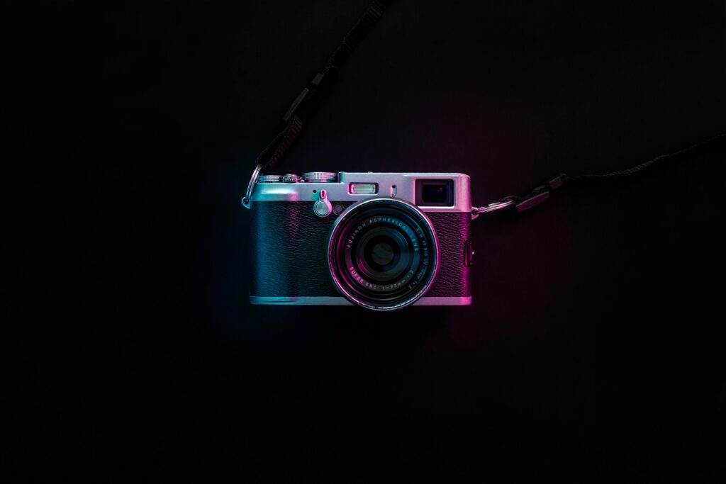 Vintage Camera Wallpaper: Neon Lit Classic Lens Aesthetic