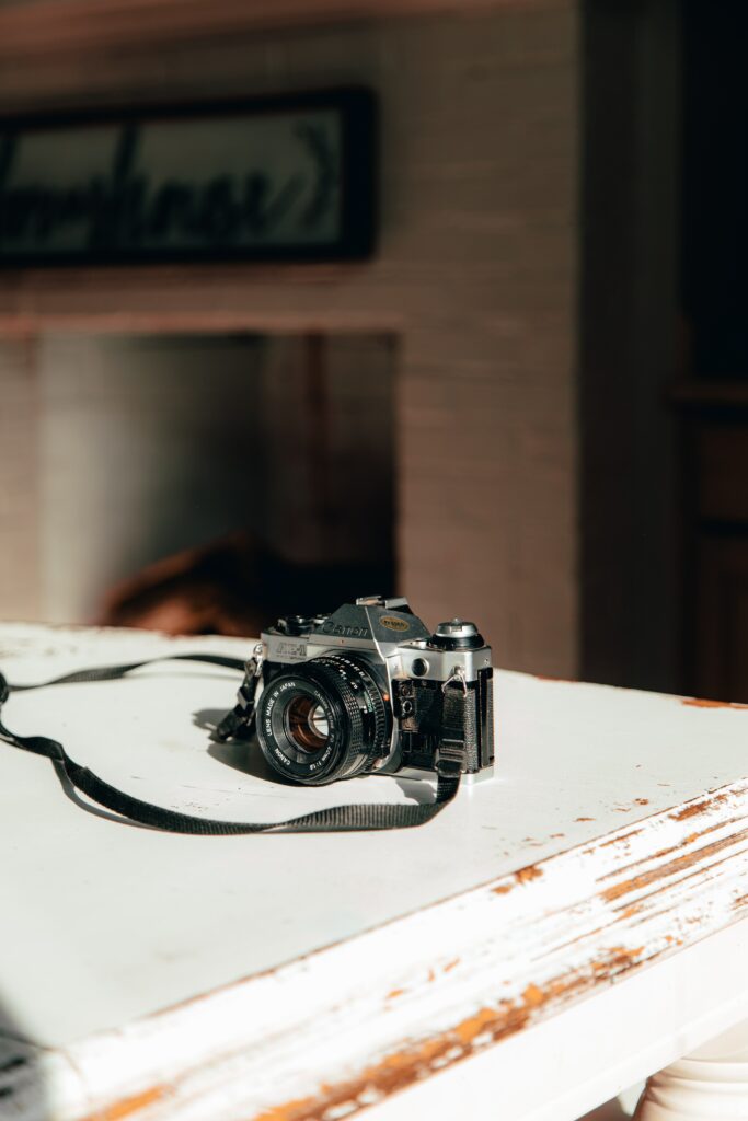 Vintage Camera Wallpaper: Rustic Table & Warm Light Background