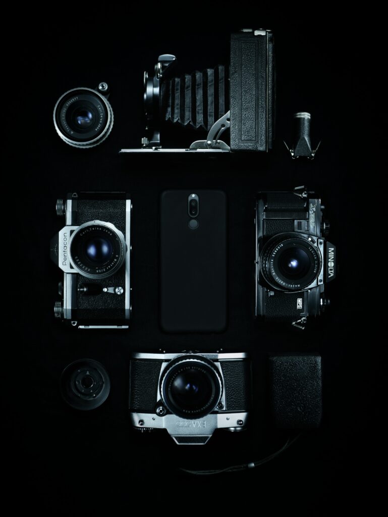 Vintage Cameras and Modern Smartphone: Retro Monochrome Wallpaper