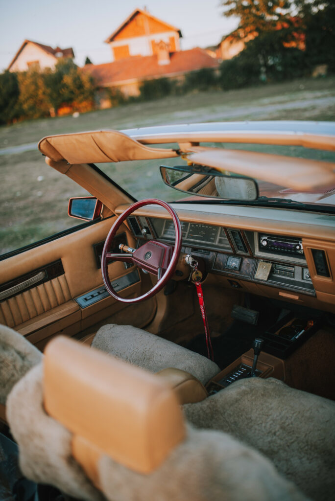 Vintage Car Interior Wallpaper: Classic Steering Wheel & Blurred Background