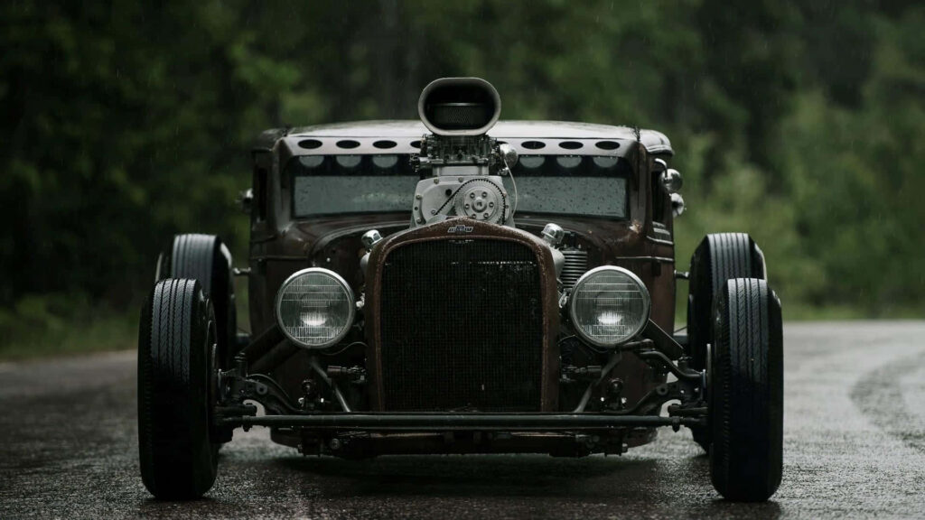 Vintage Car Wallpaper: Retro Charm on a Rainy Green Road