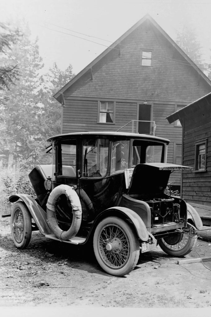 Timeless Vintage Car Wallpaper with Rustic Wooden House Background