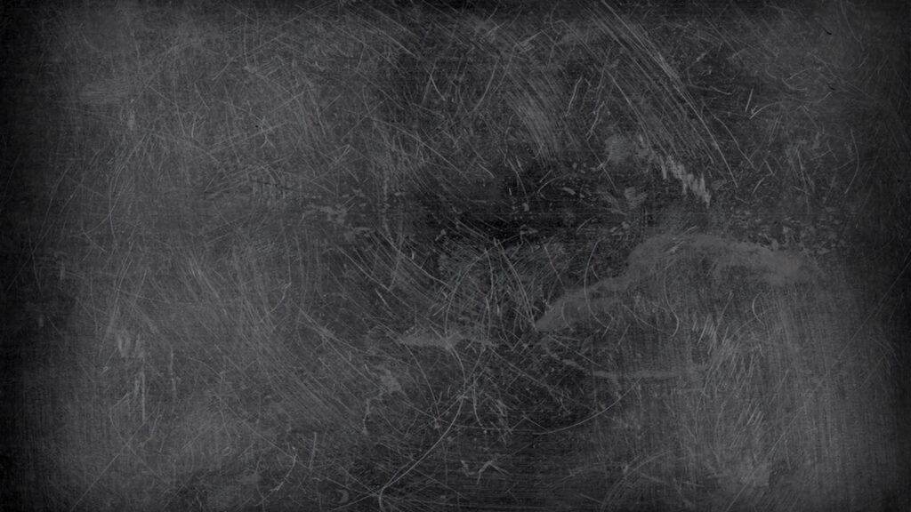 Vintage chalkboard texture with white scratches and smudges on dark gray background wallpaper
