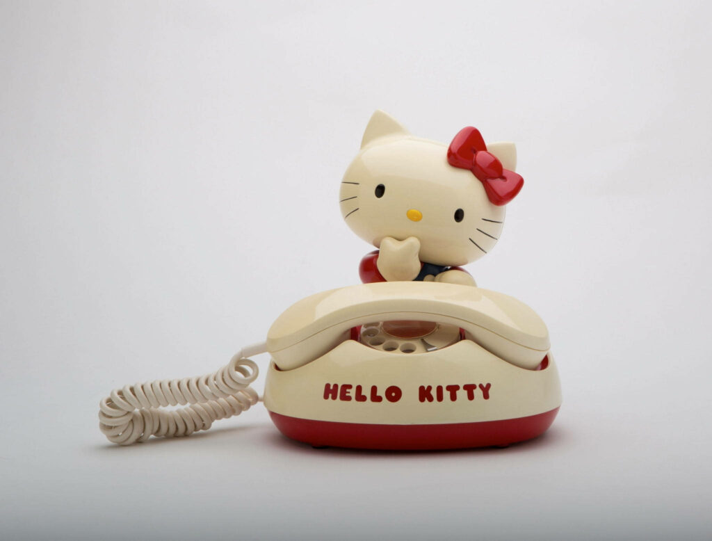 Charming Nostalgia: Hello Kitty's Vintage Telephone Delight in a Whimsical Desktop Background Wallpaper