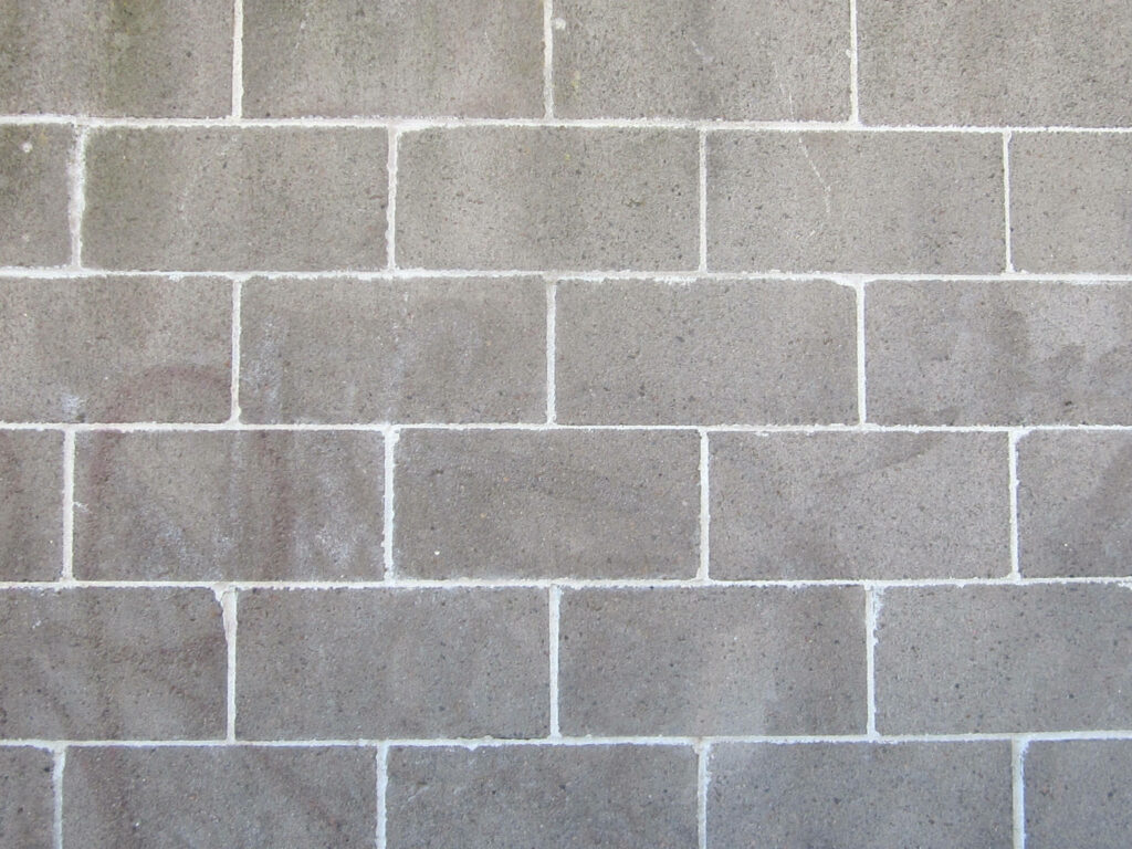 Industrial concrete block wallpaper with realistic grey cinder block texture and clean mortar lines