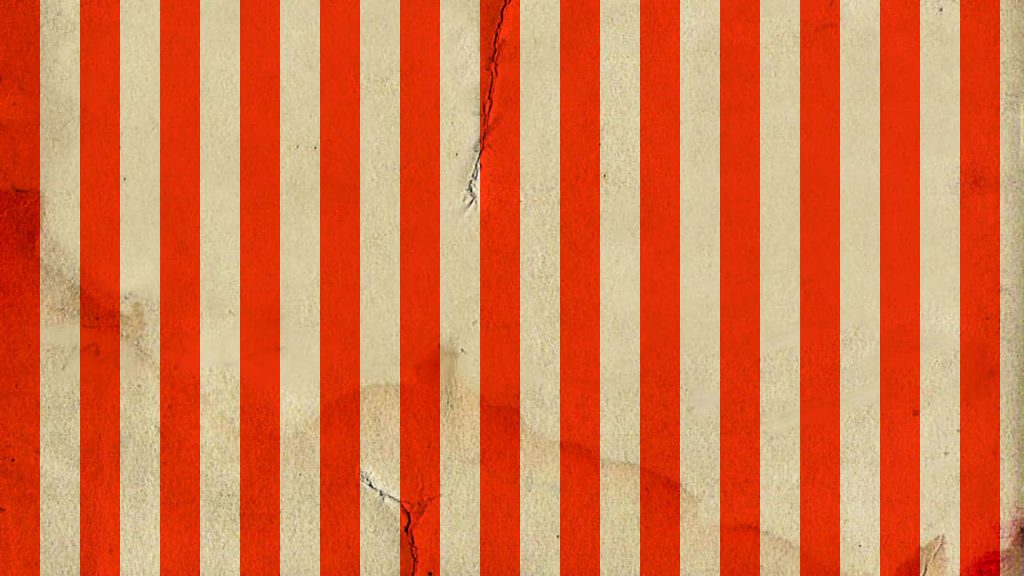 Vintage circus wallpaper with red and off-white stripes and distressed textured background