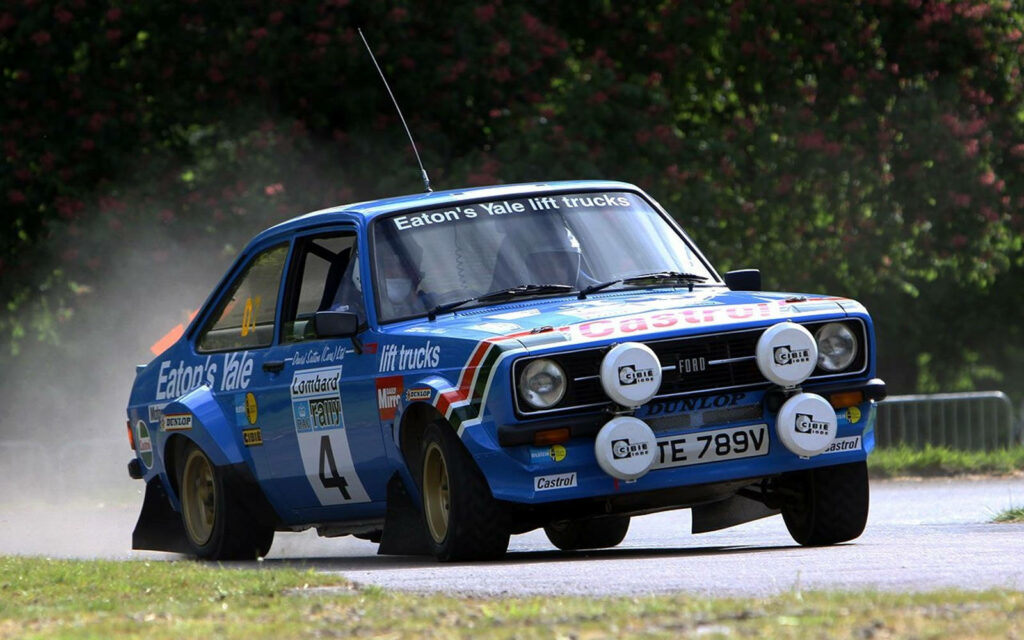 Vintage classic rally car racing a sharp turn in World Rally Championship intense wallpaper background