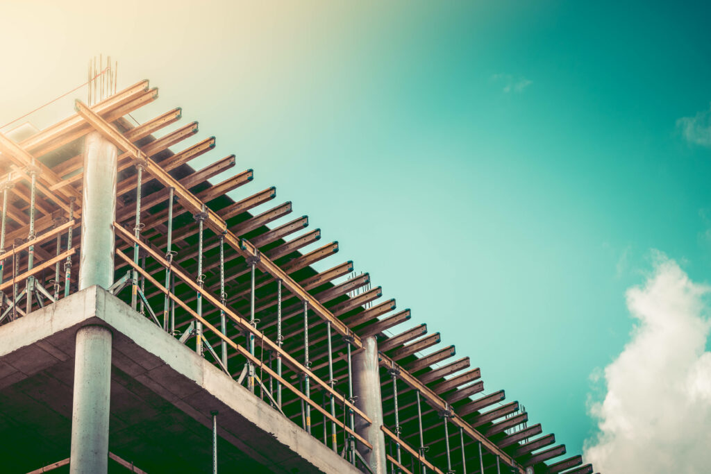 Vintage wallpaper with building construction exposed concrete columns wooden beams blue sky