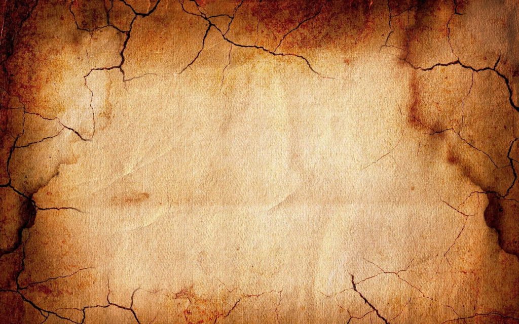Vintage crumpled parchment wallpaper with rustic brown cracked edges and warm toned center background