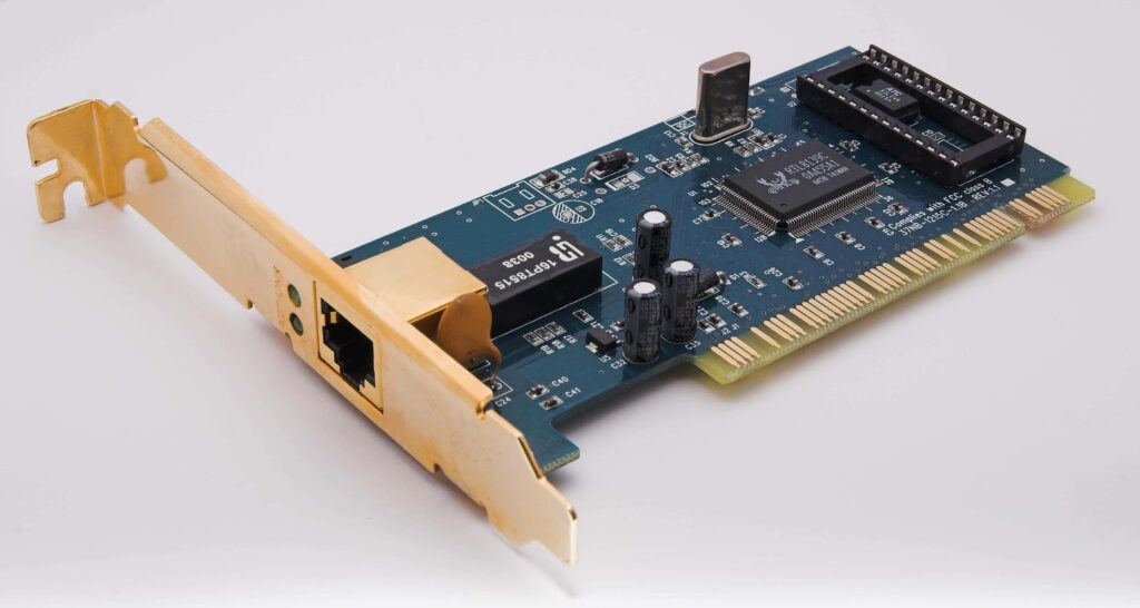 Vintage Ethernet network card close-up showing green PCB black chips and golden connectors Wallpaper