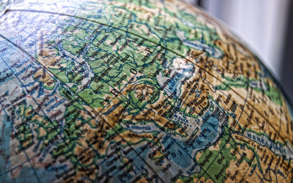 Vintage world globe macro photo showing detailed European map with antique style tones Wallpaper