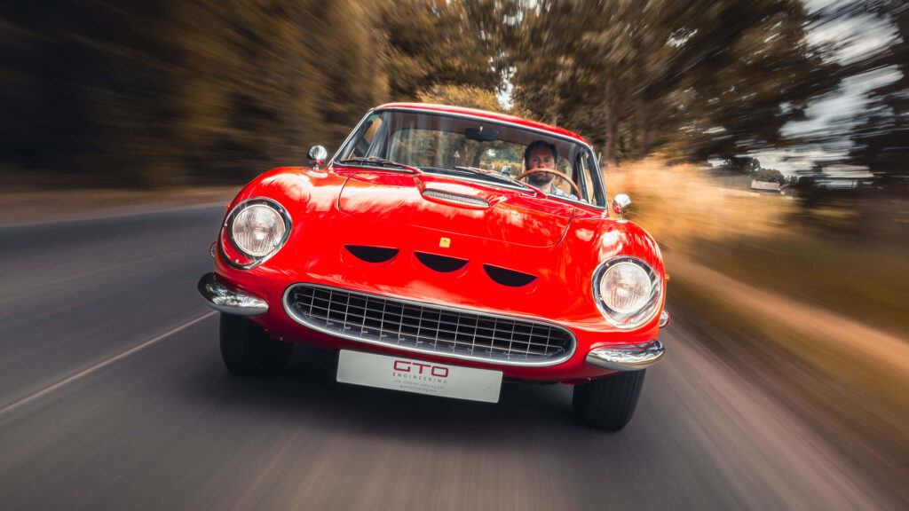 Embrace the Majesty of an Iconic Vintage Ferrari: Feel the Timeless Thrill on the Open Road Wallpaper