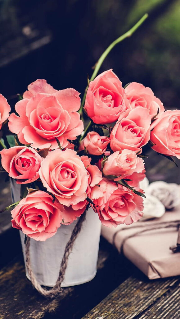Vintage Floral Aesthetic: Pink Roses in Rustic Metal Vase Background Wallpaper