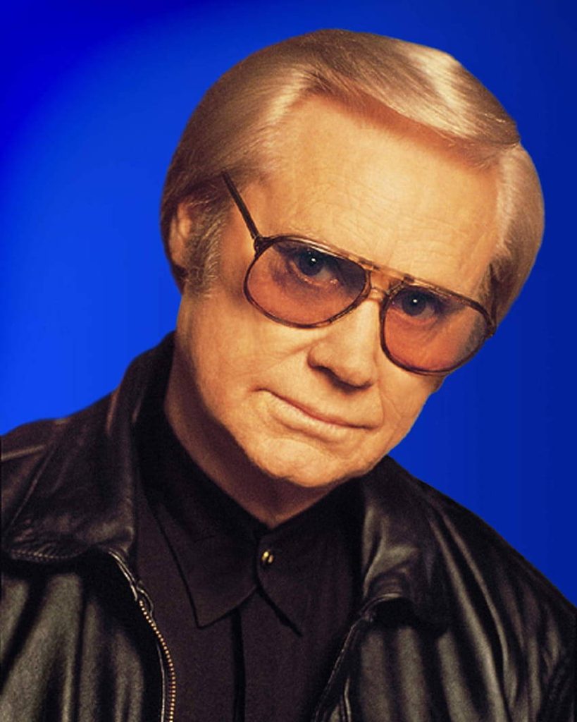 Vintage George Jones portrait in black leather jacket and tinted glasses on blue background Wallpaper