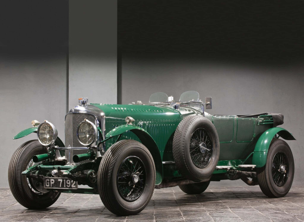 Classic Elegance: Vintage Green Bentley in Studio Setup Wallpaper