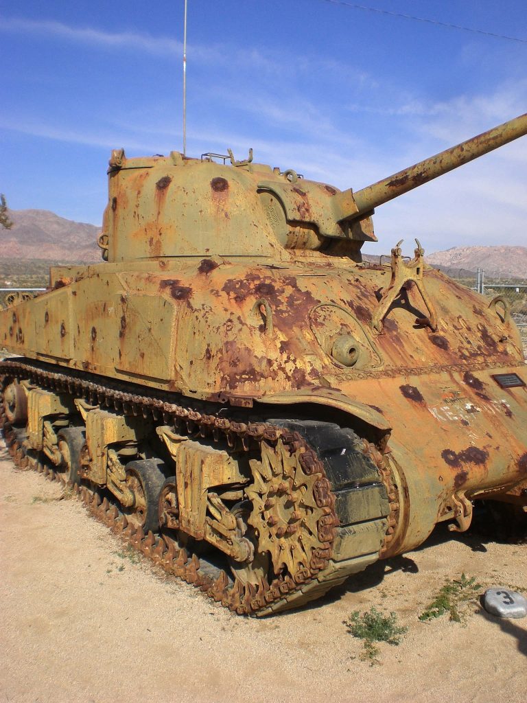 Close-up of rusted M4 Sherman tank in desert under clear blue sky historic military wallpaper