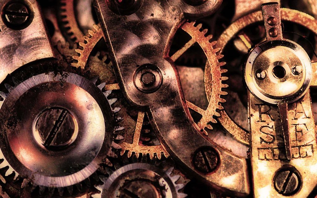 Macro shot of vintage mechanical gears with rusted cogs in warm metallic steampunk style wallpaper