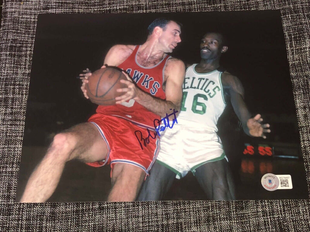 Vintage NBA wallpaper of Bob Pettit driving to basket versus Bill Russell Celtics classic rivalry