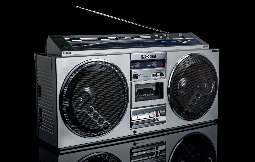 Vintage Old School Portable Boombox CFS 77L wallpaper with metallic silver design and speakers