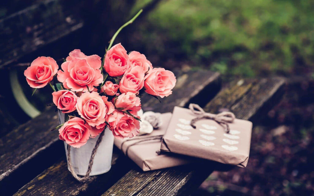 Vintage Pink Roses in Rustic Bucket on Weathered Bench Background Wallpaper